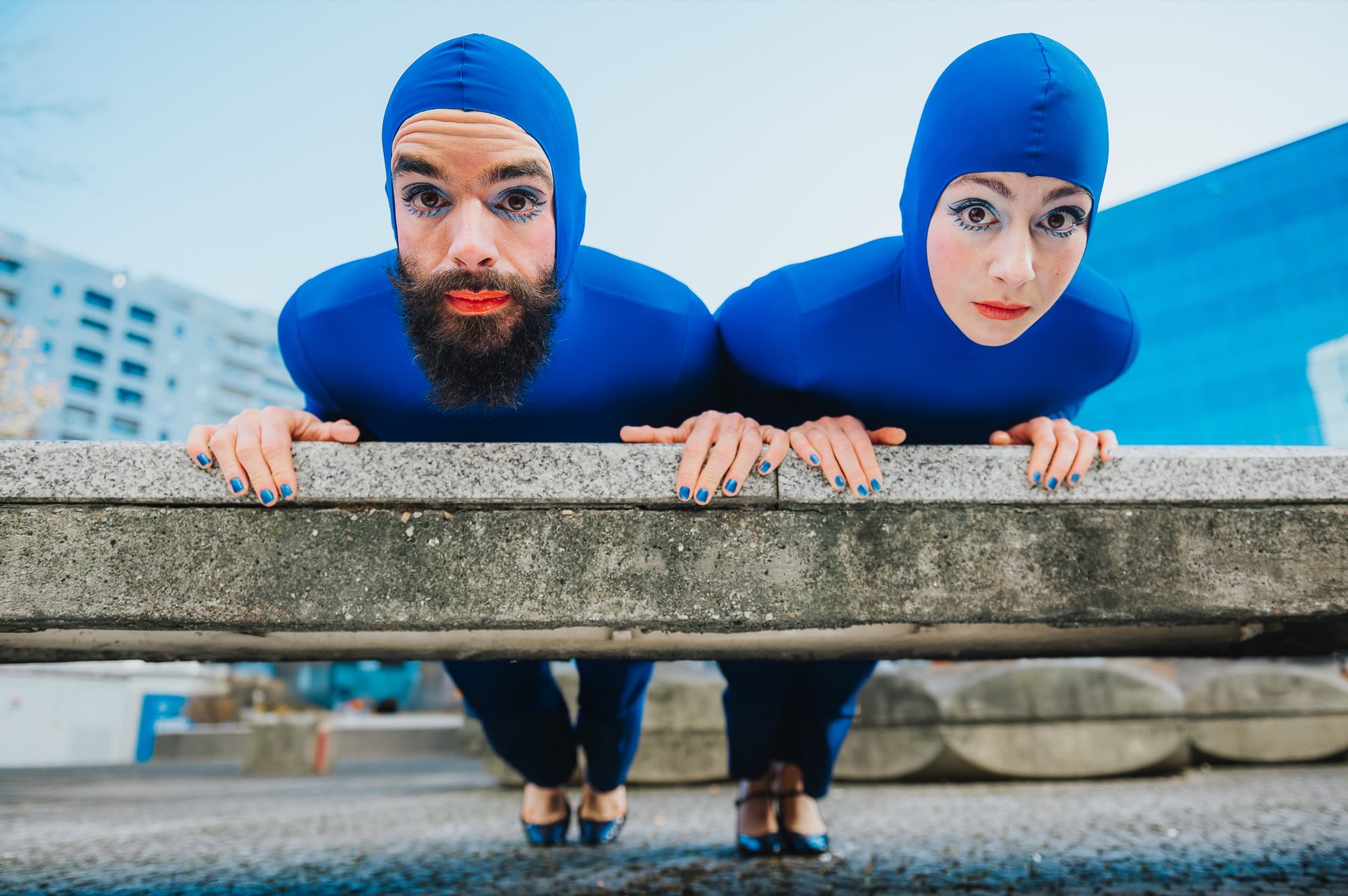 Performer in a blue costume against a dark backdrop, Blueprint