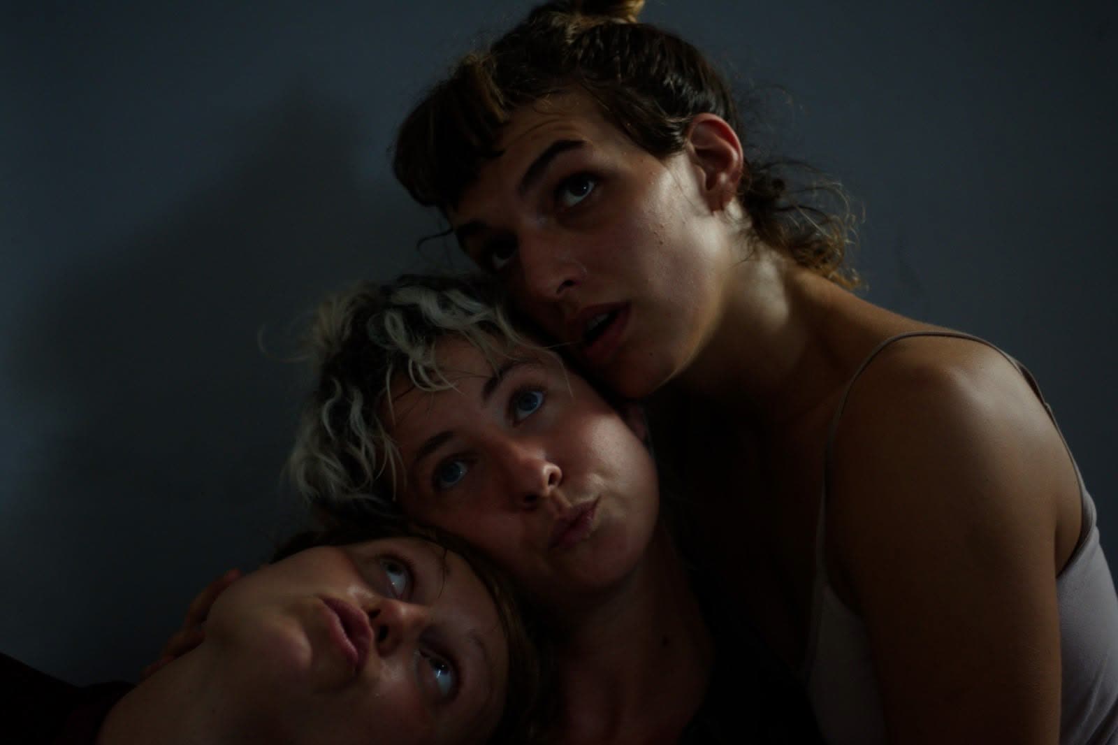 Three performers' faces close together in an intimate portrait, Everyours