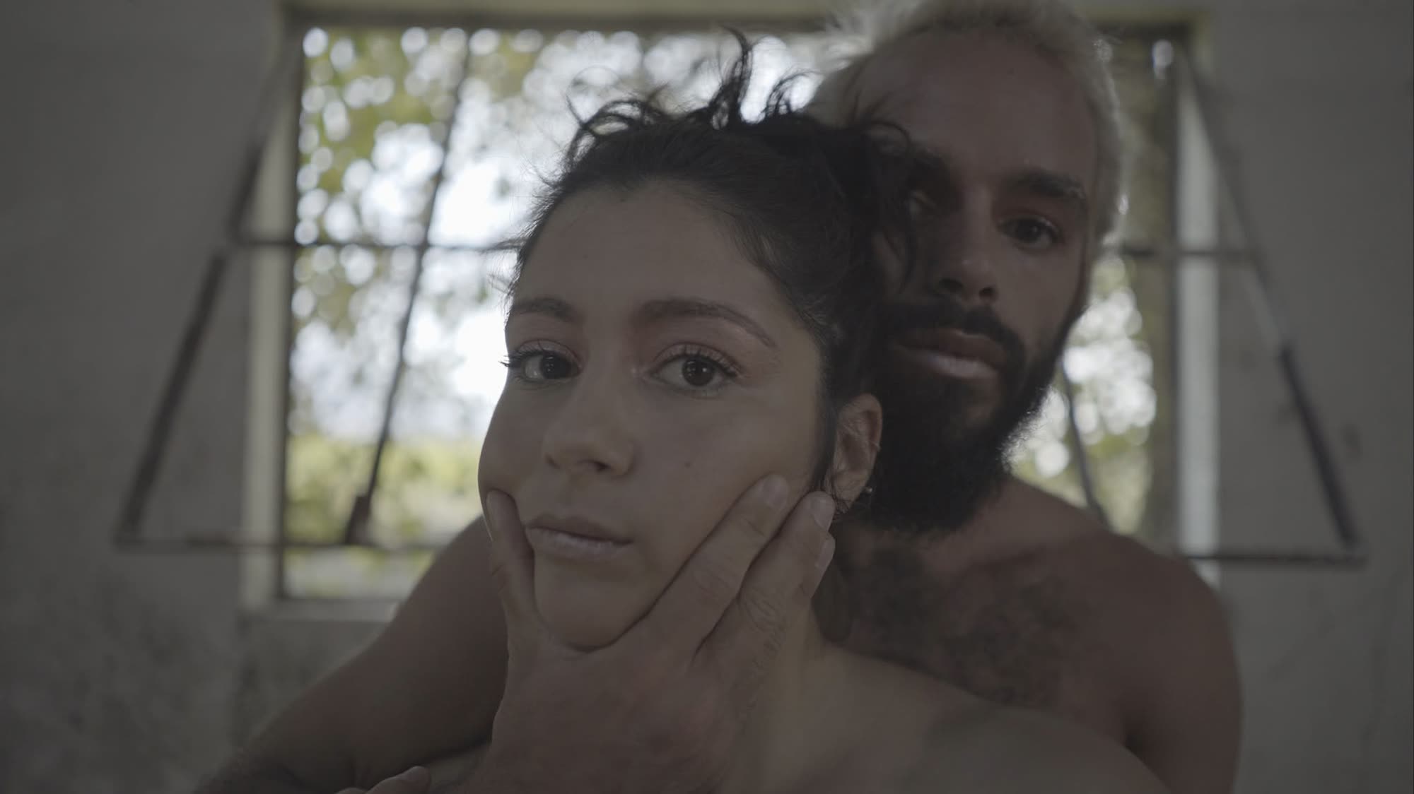 Close-up portrait of two performers by a window, In the Absence of Tenderness