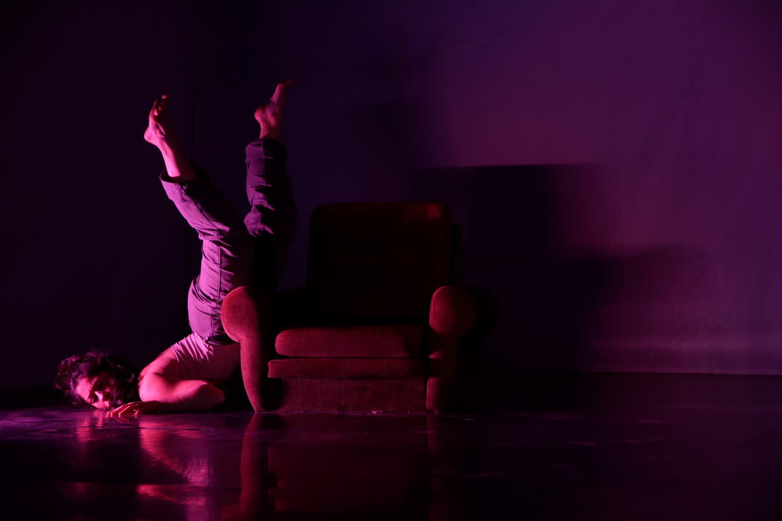 Performer in motion under purple stage lighting, When the Bells Don't Chime