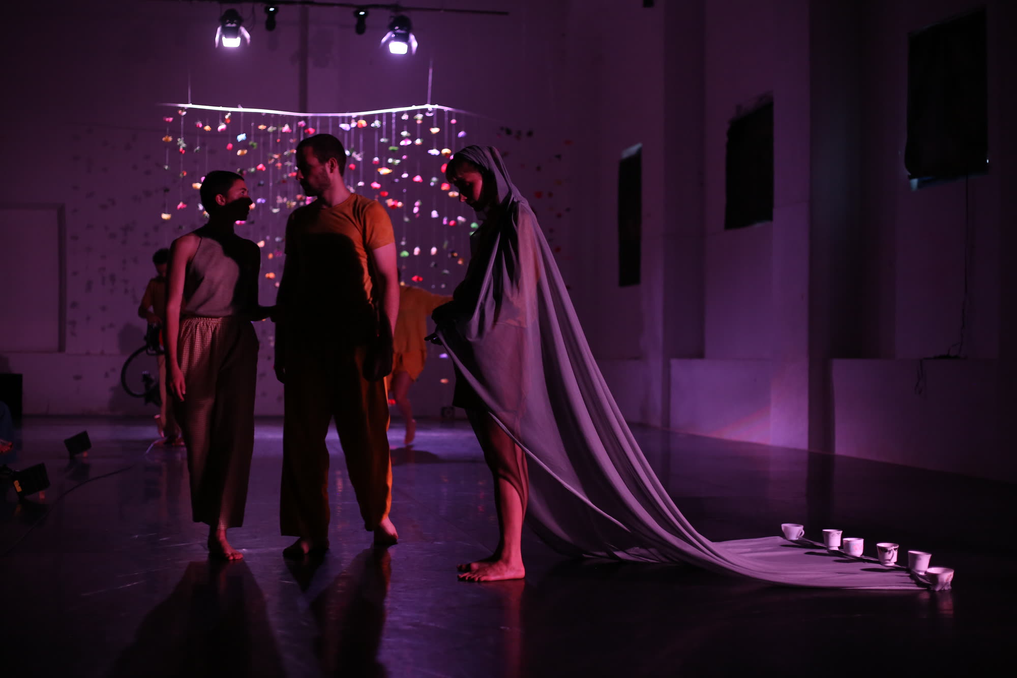 Performers in movement under stage lighting, Sonata for Vacuum and H.strings